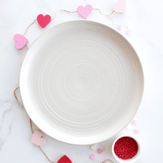 Nordic Ware | Bundt® Tea Cakes and Candies Pan on a plate, featuring heart shapes for crafting detailed mini cakes and candies.