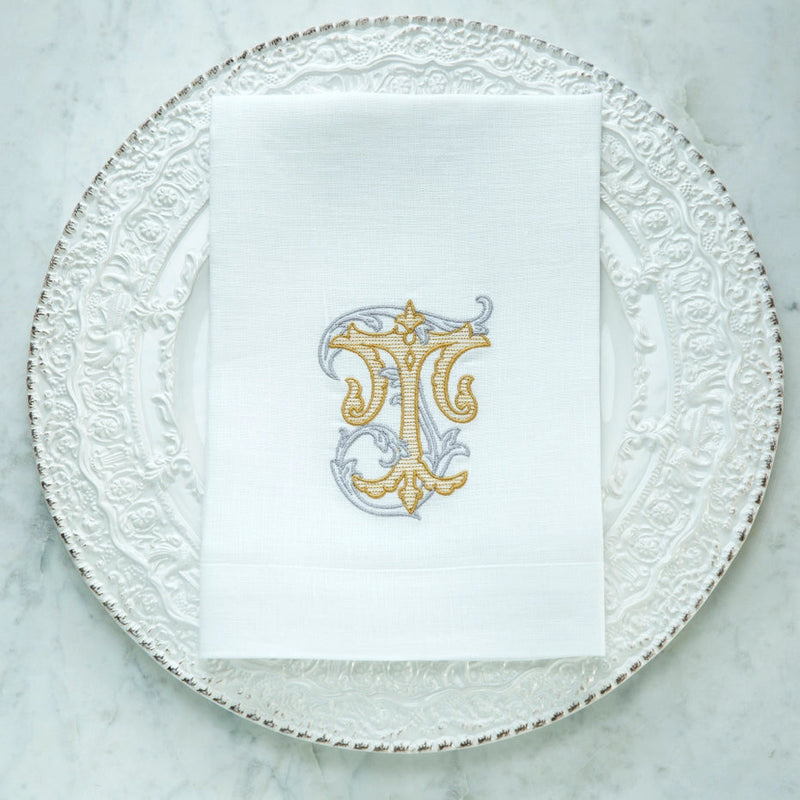 Crown Linen Designs | Vintage Vine Monogram Tri-Fold Napkin - T, showcasing elegant gold embroidery, enhances any table setting with sophistication and European linen charm.