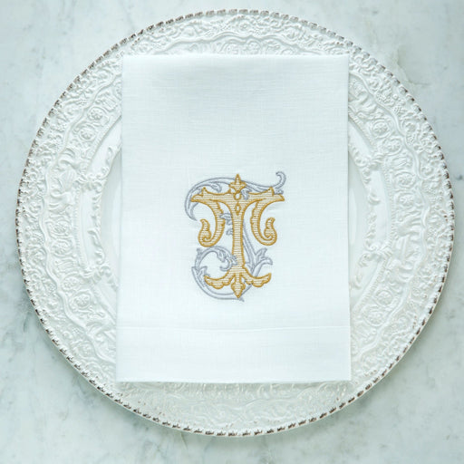 Crown Linen Designs | Vintage Vine Monogram Tri-Fold Napkin - T, showcasing elegant gold embroidery, enhances any table setting with sophistication and European linen charm.