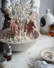 Farmhouse Pottery's 17 crafted wooden bowls, ideal for salads or decor, feature a nested design for easy storage, embodying a farm-to-table ethos.