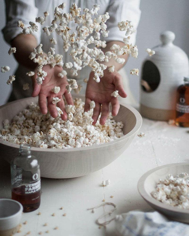 Farmhouse Pottery's 17 crafted wooden bowls, ideal for salads or decor, feature a nested design for easy storage, embodying a farm-to-table ethos.