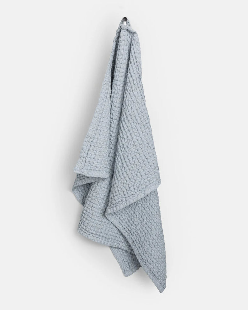 MagicLinen Waffle Kitchen Towels in Dusty Blue showcase a large, textured waffle weave, highlighting their absorbent and quick-drying qualities, ideal for enhancing your kitchen experience.