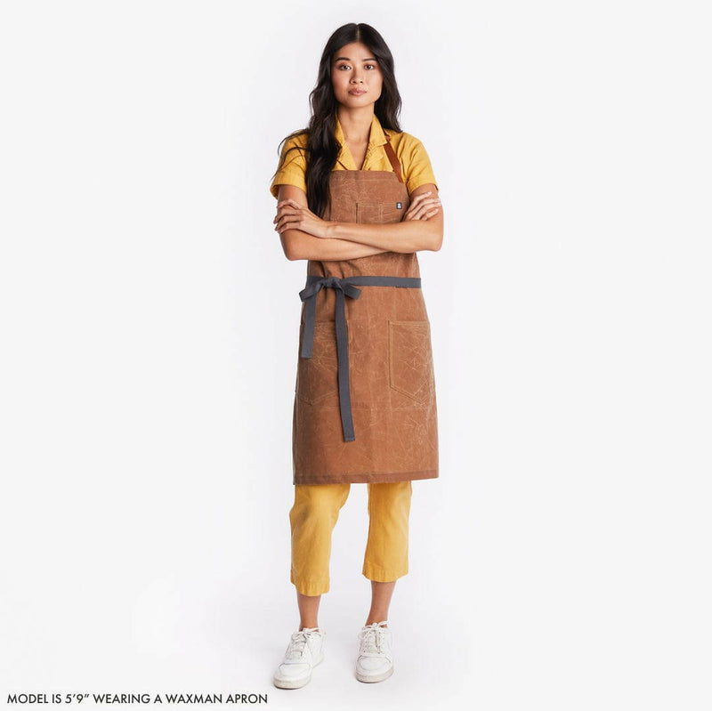 Hedley & Bennett | Essential Waxed Canvas Aprons - Montana; durable apron with leather neck strap, navy waist tie, utility loop, ideal for cooking and DIY projects.