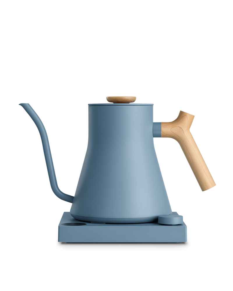 FELLOW | Stagg EKG Pro Electric Kettle, Hazy Blue w/ Maple, on base with control dial, ideal for precision brewing coffee or tea.