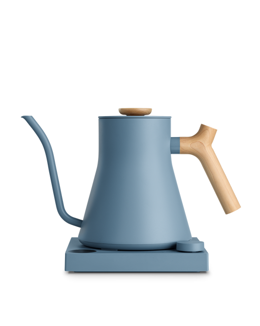 FELLOW | Stagg EKG Pro Electric Kettle, Hazy Blue w/ Maple, on base with control dial, ideal for precision brewing coffee or tea.