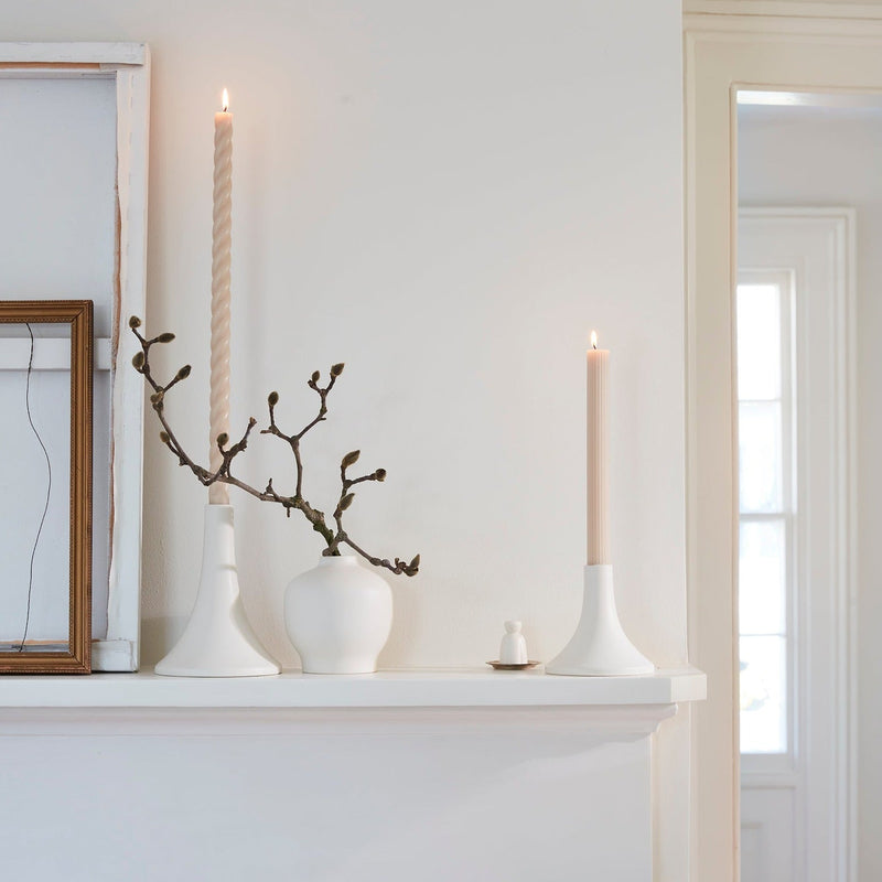 The Floral Society | Candle Holders, Grand, Matte White Tall, beautifully displayed on a minimal mantel with lit taper candles and understated decor.