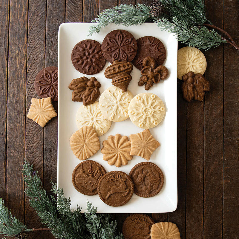Nordic Ware | Snowflake Cookie Stamps - Set of 3 featuring cast aluminum stamps and painted wooden handles, perfect for creating embossed snowflake cookies effortlessly.