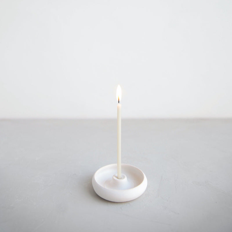 The Floral Society | Wishing Candles, Miel: A slender white candle with a small flame in a minimalist white holder, ideal for elevating everyday moments or celebrations.