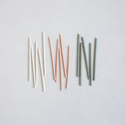 The Floral Society | Wishing Candles, Miel: A set of unlit taper candles in off-white, soft pink, and sage green, ideal for enhancing everyday moments or special gatherings.