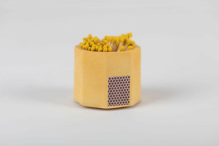 Close-up of Tenn Prairie Match Holder with Striker, featuring a hand-poured concrete vessel and 70 included matches, highlighting its practicality for kitchen use.