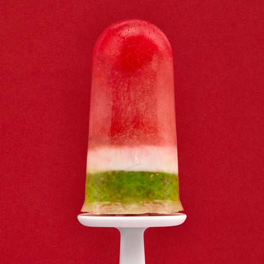 Zoku | Classic Pop Mold showcasing a red and green popsicle on a white plate, ideal for crafting homemade frozen treats.