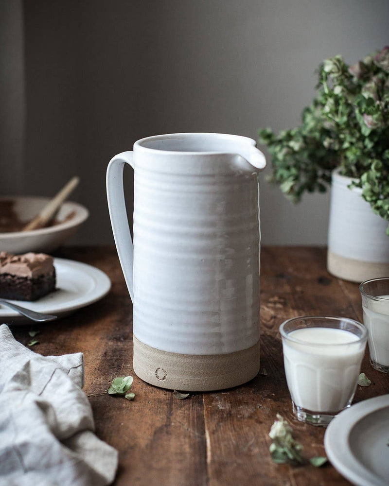 Farmhouse Pottery - Silo Pitchers: Petite, displayed with milk glasses and dessert on a rustic table, highlighting its versatile, minimalist design for kitchen use.