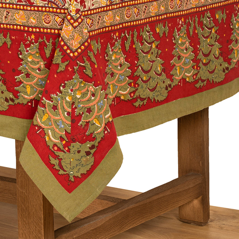 Couleur Nature - Noel Red & Green French Tablecloth: 71 x 106, featuring festive Christmas patterns in red and green on finely crafted French linen, draped over a wooden table.