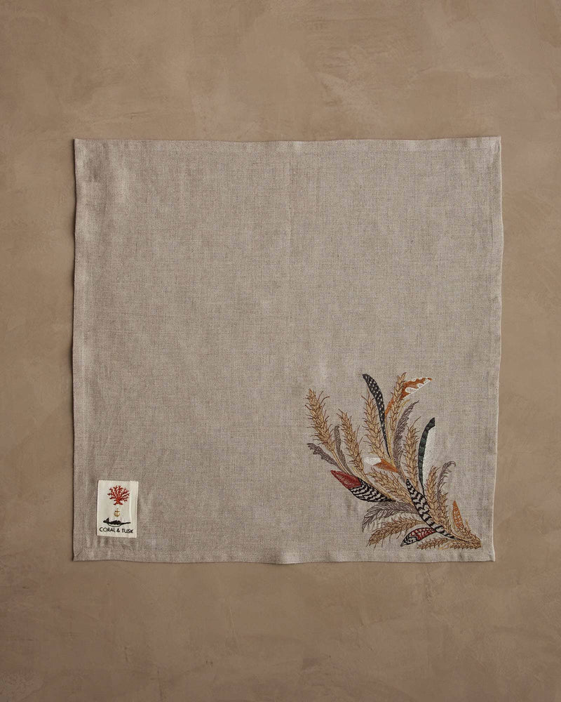 Coral & Tusk - Wheat Harvest Dinner Napkin featuring embroidered grasses and feathers in gold hues, showcasing a bountiful fall theme, ideal for an elegant table setting.