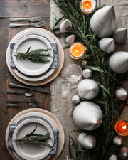 Rustic table setting featuring Farmhouse Pottery - Spruce Woodland Trees: Petite, amidst greenery and candles, on a wooden table with elegant dinnerware and linens.