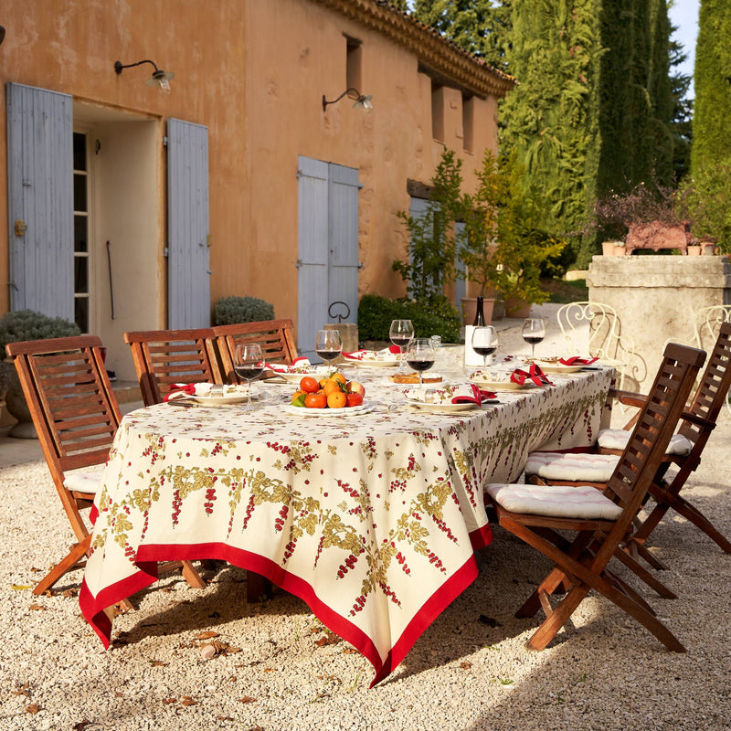 Couleur Nature - Gooseberry Red & Green tablecloth on a Mediterranean-style dining table, with wine glasses and citrus, embodies casual elegance and French-inspired design.