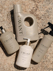 L’AVANT Collective Hand Soap Ambre Santal, alongside detergent, dish soap, and cleaner, showcasing eco-luxe cleaning essentials in minimalist, reusable bottles.