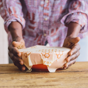 Bee's Wrap - Cut-to-Size Roll - Honeycomb held by a person, showcasing its flexible, reusable features for sustainable food storage.