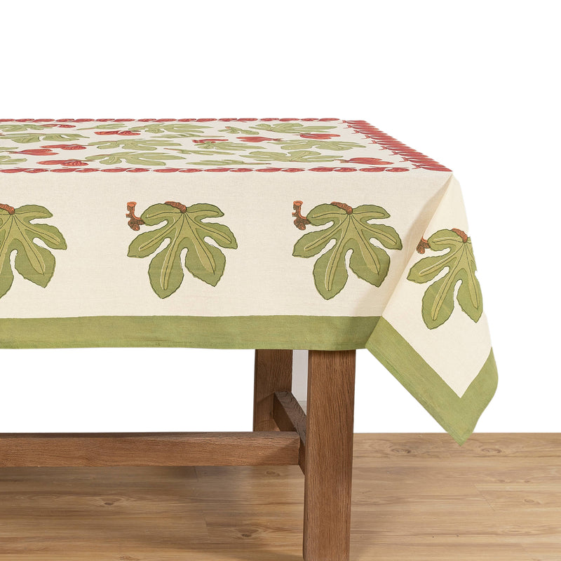 Couleur Nature - Fig Red & Green | French Tablecloth: 71 x 71 with fig leaf and red accents on a wooden dining table, enhancing kitchen elegance.