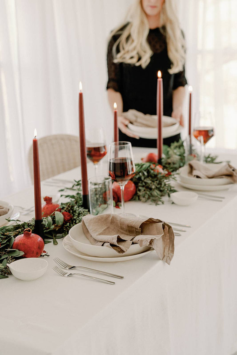 Mo&Co Home - Burgundy Dipped Beeswax Taper Candles, 14 inches, elegantly adorn a festive table, adding warm ambiance with eco-friendly, handcrafted charm.