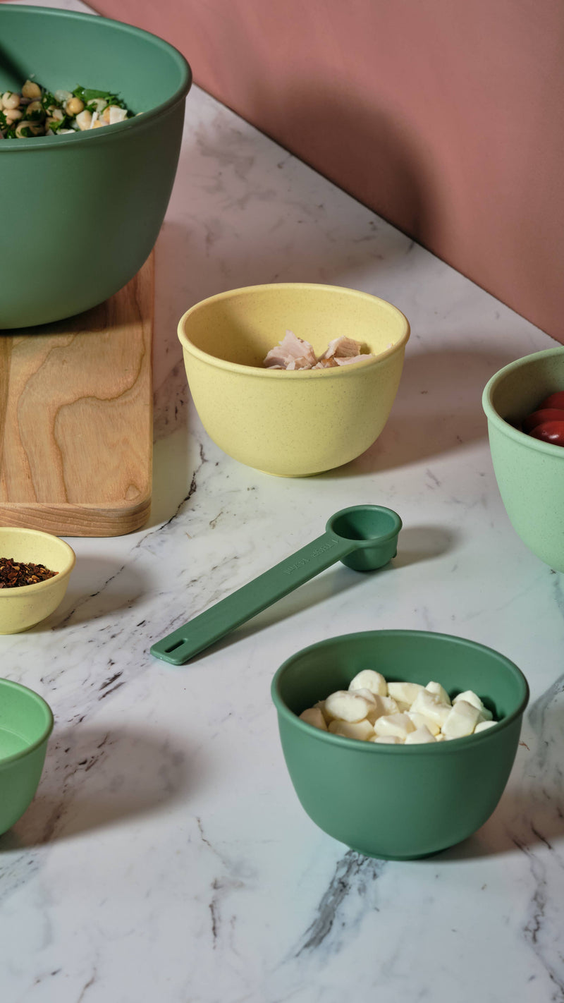 Bamboozle - 5-Piece Astrik Mixing Bowl Set: Fresh Guacamole, featuring bowls and a measuring spoon on a marble surface, showcasing eco-friendly kitchenware from Athens Cooks.