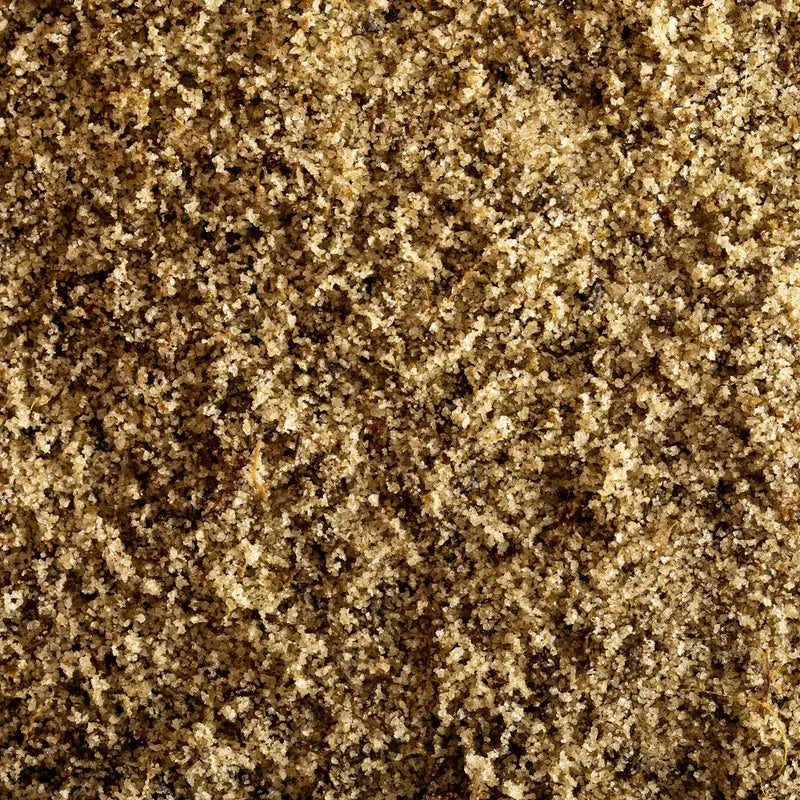 Jacobsen Salt Co. - Rosemary Salt - Infused Sea Salt, macro view of granulated sugar-like crystals, perfect for enhancing roasted lamb, focaccia, and shortbread cookies.