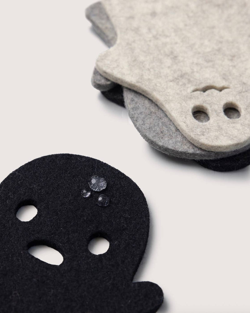 Graf Lantz - Merino Wool Spooky Coaster Multi 4 Pack featuring ghost-face shaped felt coasters, showcasing durability and style with beaded water droplets on black felt.