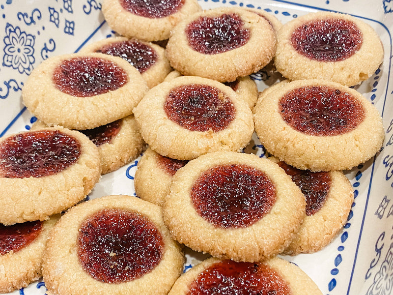 Southern Roots Sisters - Triple Berry Jam thumbprint cookies on a decorative dish, highlighting the jam's blend of strawberries, blackberries, and blueberries for a flavorful treat.