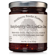 Southern Roots Sisters Raspberry Chipotle Jam in a glass jar, featuring fresh raspberries and spicy chipotle peppers, ideal for cheeses, meats, and desserts.