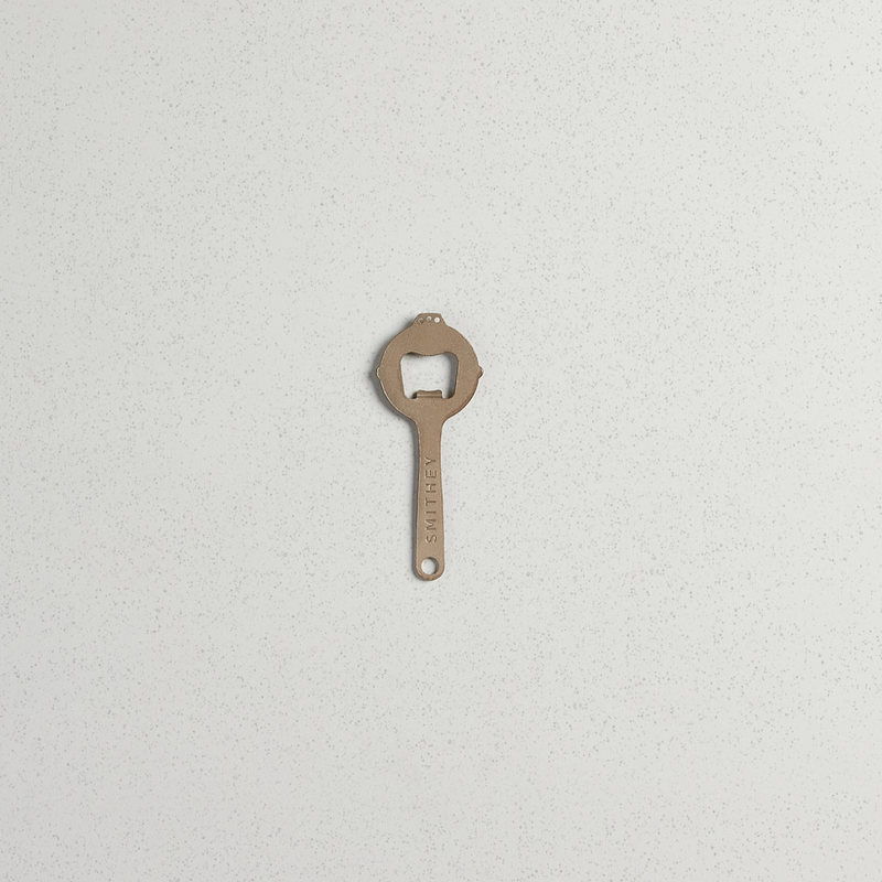 Smithey bottle opener, complete skillet-shaped profile on a light background