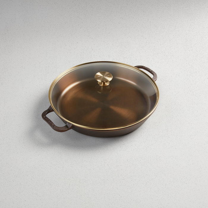 Smithey | Glass Lids showcasing a close-up view of a brass pot handle, ideal for enhancing your kitchenware collection from Athens Cooks.