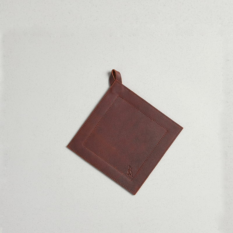 Smithey full-grain leather potholder with stitched border and hanging loop