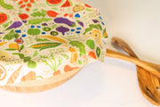 Bee's Wrap - New! Garden Party - Assorted 3 Pack with a cloth-covered bowl and wooden spoon, showcasing reusable food storage wraps.