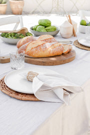 MagicLinen - Set of 2 linen napkins displayed on a table with food, showcasing their versatility and premium quality, ideal for enhancing table decor.