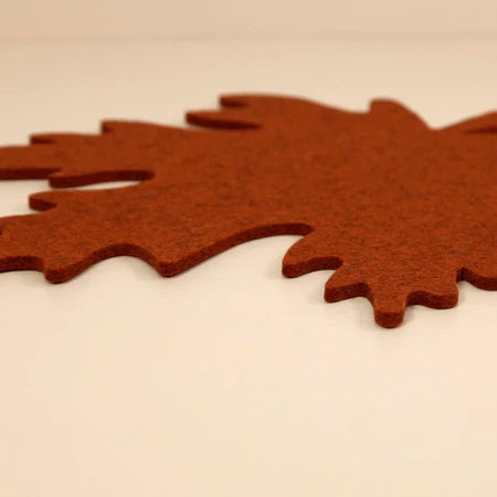 Graf Lantz | Merino Wool Autumn Trivet - Mahogany, shaped like a felt leaf, enhances your table's aesthetic while protecting it from heat.