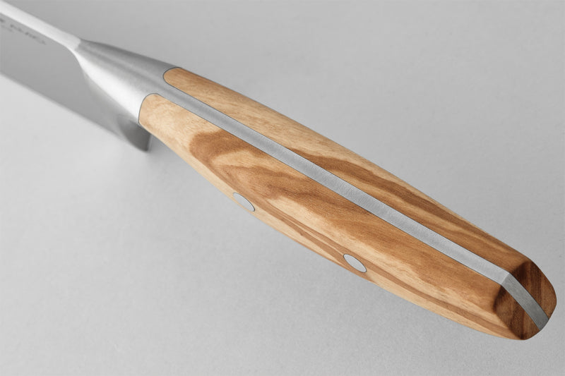 Wüsthof Amici 7 Santoku knife with a metal and wood handle, highlighting its precision tool design for kitchen use.