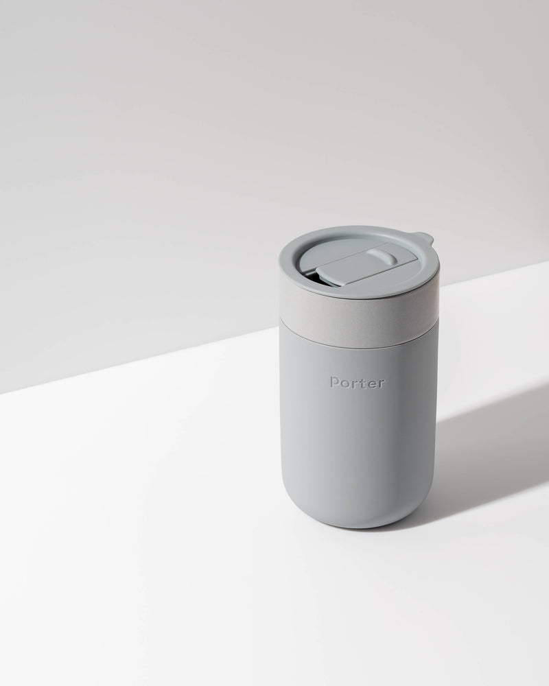 W&P - Ceramic Reusable Coffee Mug 16oz: Charcoal, featuring a grippable silicone sleeve and splash-resistant lid, ideal for eco-friendly, stylish coffee enjoyment.