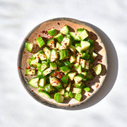 Villa Jerada - Aleppo - 60g sprinkled on cucumber salad in rustic bowl, enhancing flavor with its bright, savory fruitiness and subtle heat.