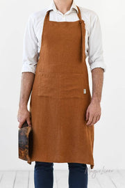 Man wearing MagicLinen - Men's linen bib apron with front pocket, ideal for cooking or grilling, featuring adjustable straps and roomy pocket for convenience.