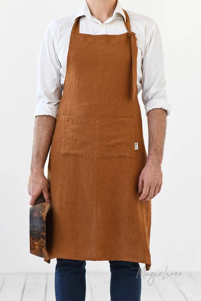 Man wearing MagicLinen - Men's linen bib apron with front pocket, ideal for cooking or grilling, featuring adjustable straps and roomy pocket for convenience.