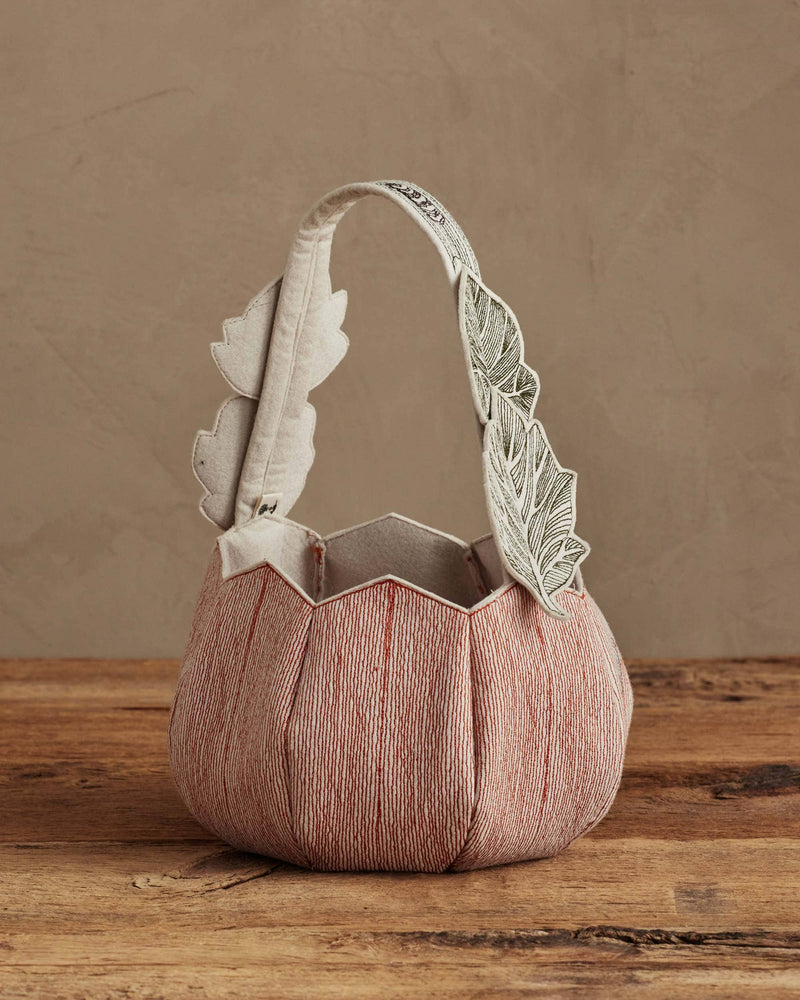 Coral & Tusk - Jack-o'-Lantern Basket, a fabric tote with stitched panels, scalloped rim, and appliquéd leaves on the handle, perfect for Halloween treats.