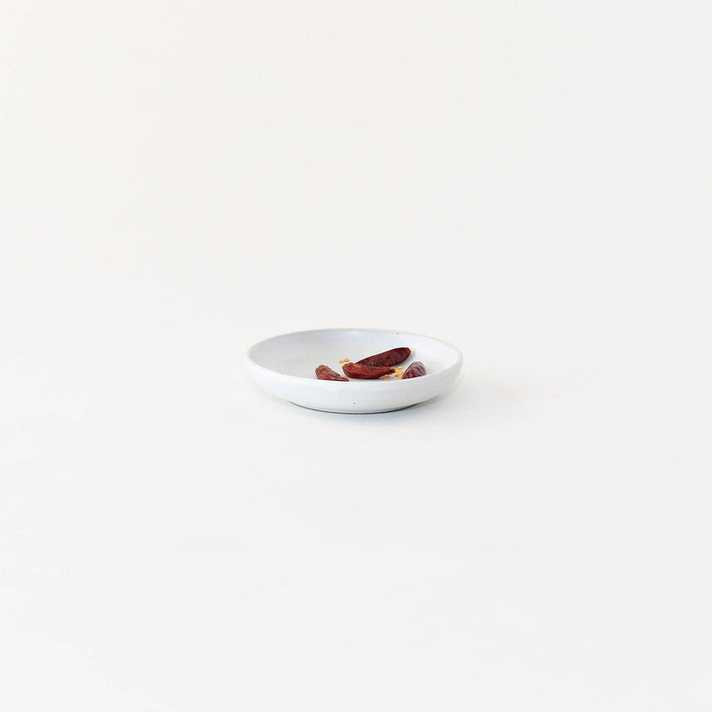 Sarah Kersten - Olive Dish: Basin Collection: Dove Grey, a small, shallow plate holding red hot peppers, ideal for olives or bread, 6 diameter, versatile for kitchen use.