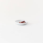 Sarah Kersten - Olive Dish: Basin Collection: Classic White, shown with dried fruit and red hot peppers, highlighting its versatility and elegance for appetizer presentation.