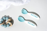 BEABA Toddler's Self-Feeding Cutlery - Breeze, featuring a close-up of ergonomic toddler spoon and fork from the 10-piece set, designed for safe self-feeding.