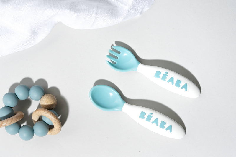 BEABA Toddler's Self-Feeding Cutlery - Breeze, featuring a close-up of ergonomic toddler spoon and fork from the 10-piece set, designed for safe self-feeding.