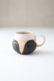 Gravesco Pottery - Transformation Mug Petite: Hand-thrown ceramic mug with cream glaze and charcoal wood-grain design, embodying transformation and feminine strength, perfect for a double espresso.