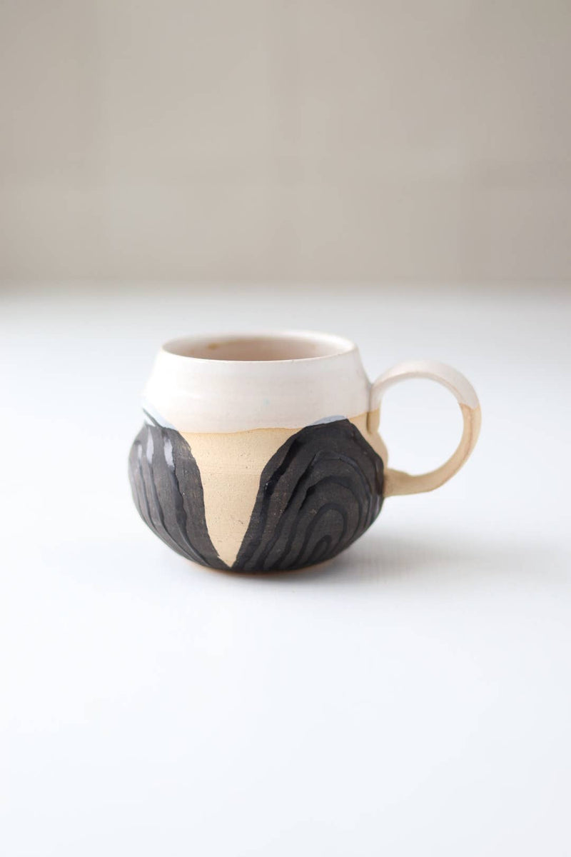 Gravesco Pottery - Transformation Mug Petite: Hand-thrown ceramic mug with cream glaze and charcoal wood-grain design, embodying transformation and feminine strength, perfect for a double espresso.