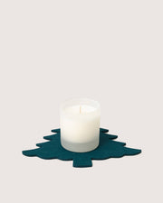 Graf Lantz - Merino Wool Tree Trivet in Kombu under a white candle, showcasing its stylish, functional design for protecting kitchen surfaces.