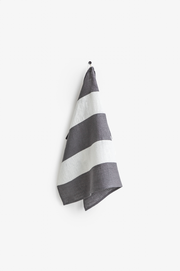Striped linen tea towel on a hook, featuring a hanging loop. Part of MagicLinen's zero-waste program, ideal for stylish, eco-friendly kitchen use.