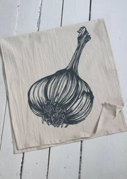 Hearth and Harrow organic cotton tea towel featuring a hand-printed garlic design, perfect for kitchen use. Eco-friendly and stylish, ideal for any cooking enthusiast.